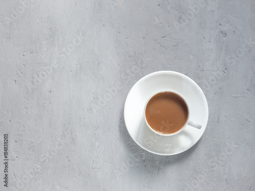 Cup of fragrant coffee on a background under the concrete. Minimalism is the view from the top. Copy space