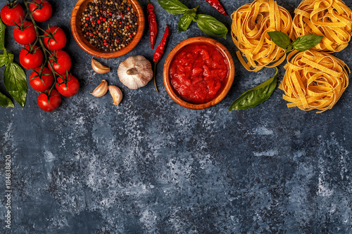 Italian food background with pasta, spices and vegetables.