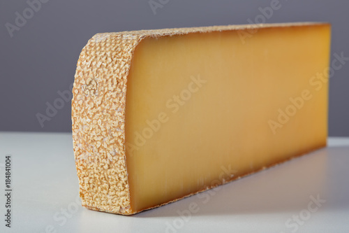 French cheese comté on grey background.