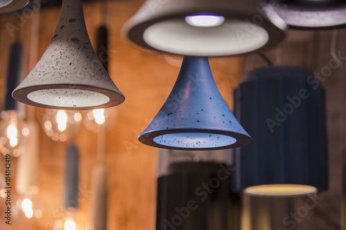 Modern light bulbs in a cafe. Ceiling light fixtures. Chandelier from cement photo