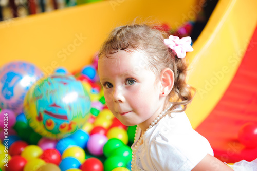 Girl playing on the playground, in the children's maze.