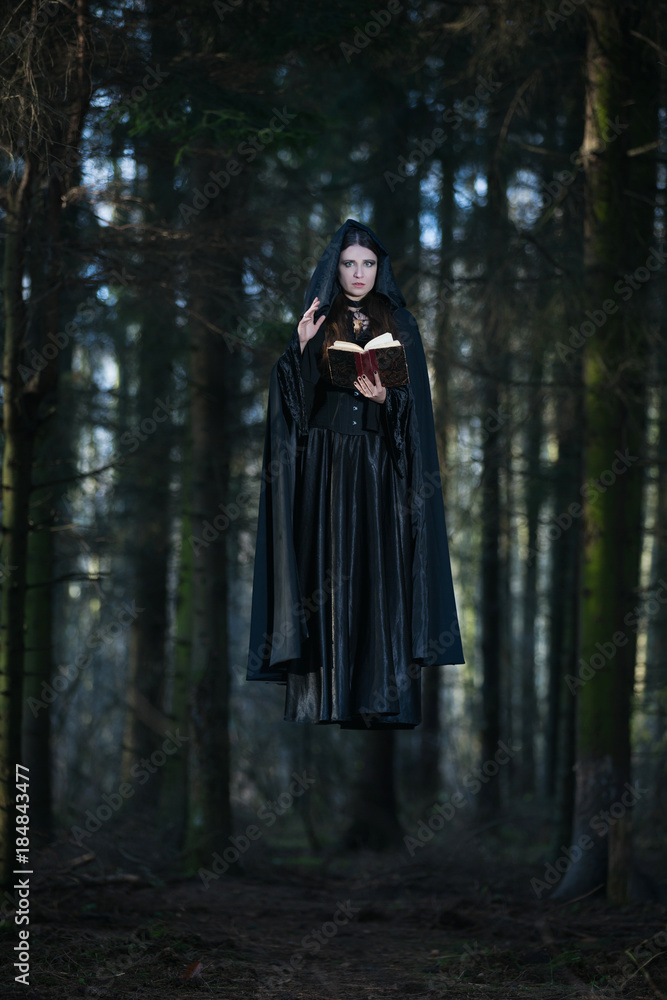 A witch celebrating the spells from the book A witch celebrating the spells from the book