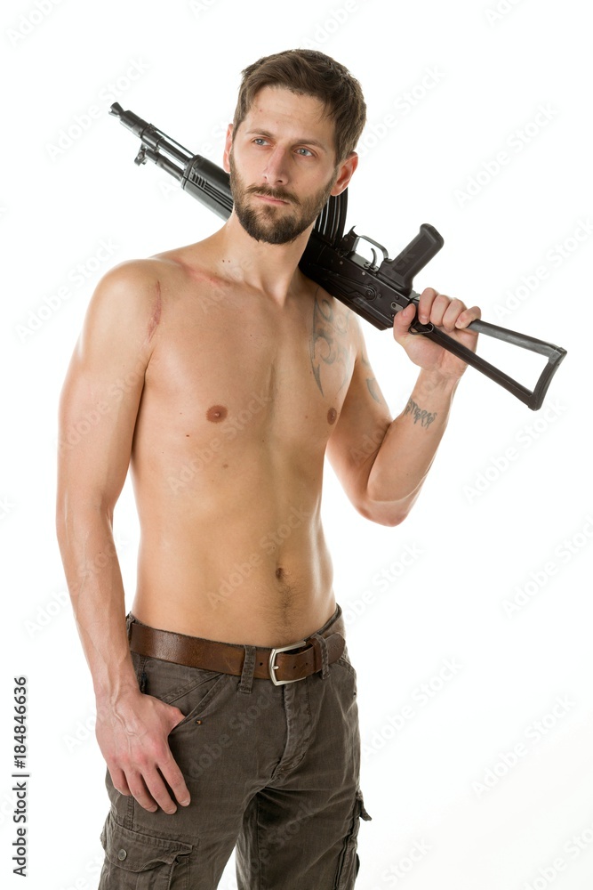 Man with a beard of a bandit with a naked torso with a Kalashnikov rifle on white background