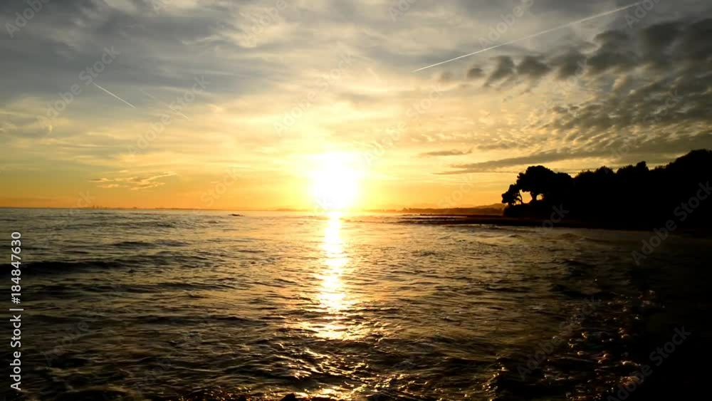 The calm sea in a very cloudy sunset The calm sea in a very cloudy sunset