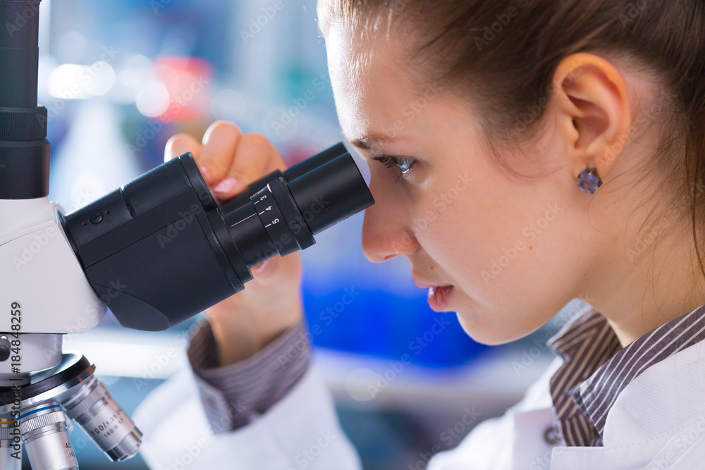Fotografie Young scientist studying Pathological microorganism  in microscope