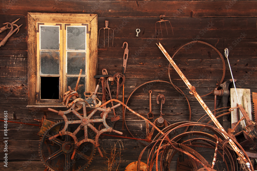 Fotografie old agricultural tools on a wooden wall with a window