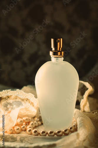 Perfume bottle with white pearls