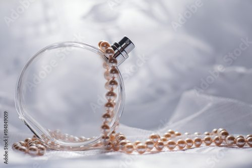 Perfume bottle with white pearls