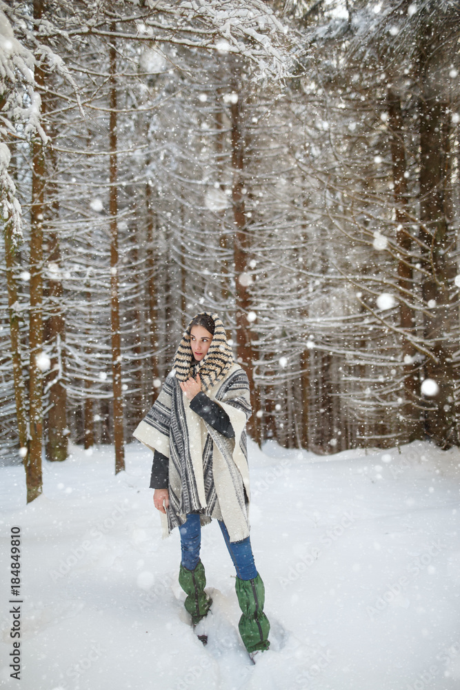 Happy young woman walking in winter forest. Happy girl having fun in the snow. Snow covered trees. Snowy pine trees on a winter landscape. snovy trees on winter mountains