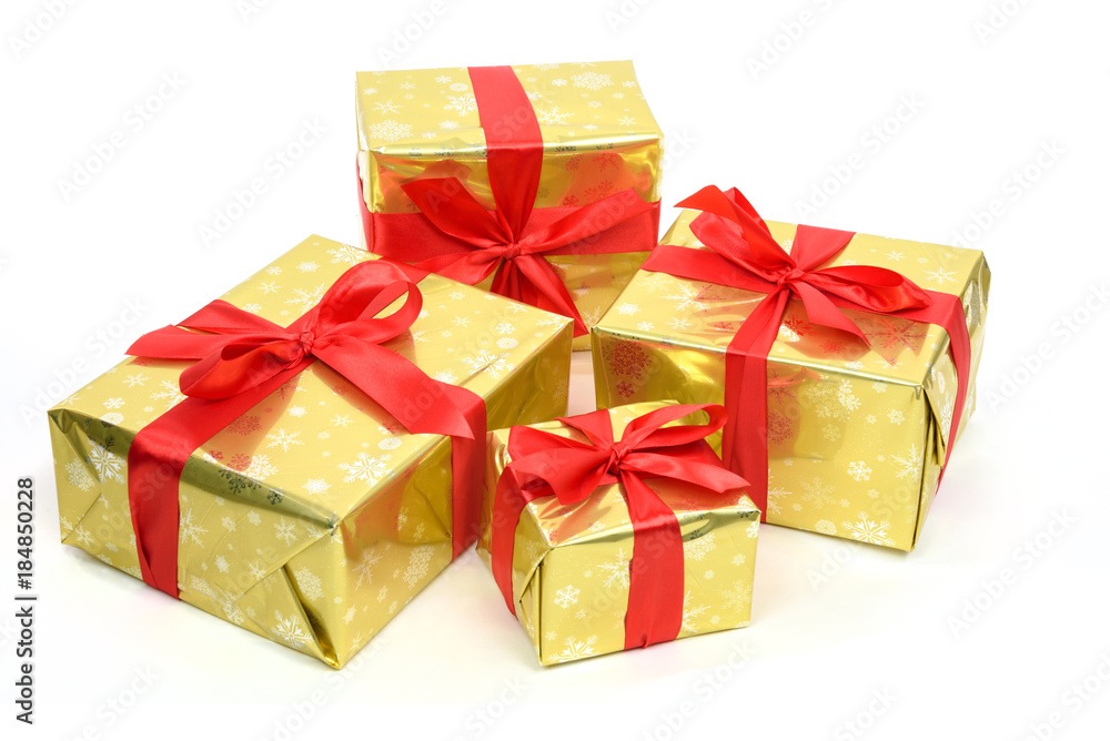 Fototapeta premium Concept of luxury Christmas gifts - boxes packed in golden paper and tied with a red satin ribbon on a white background