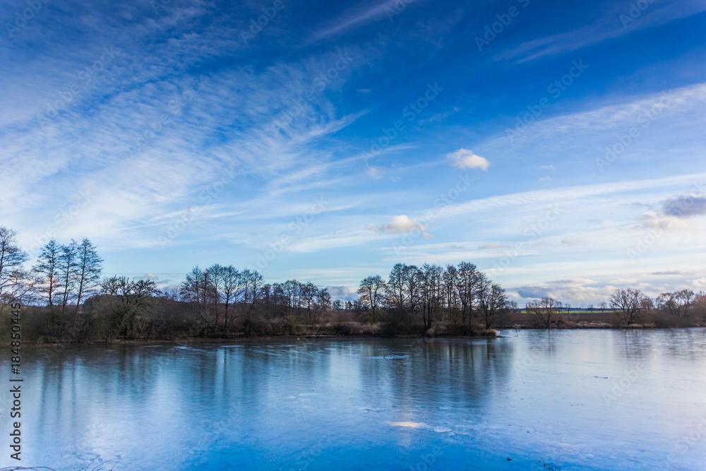 Cold lake under a blue sky in the winter. Czech republic.