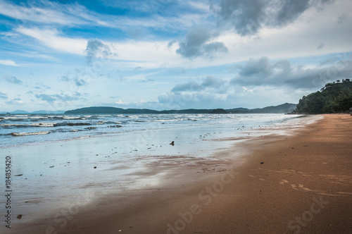 Beautiful sunny beach with blue sky and white clouds on the background