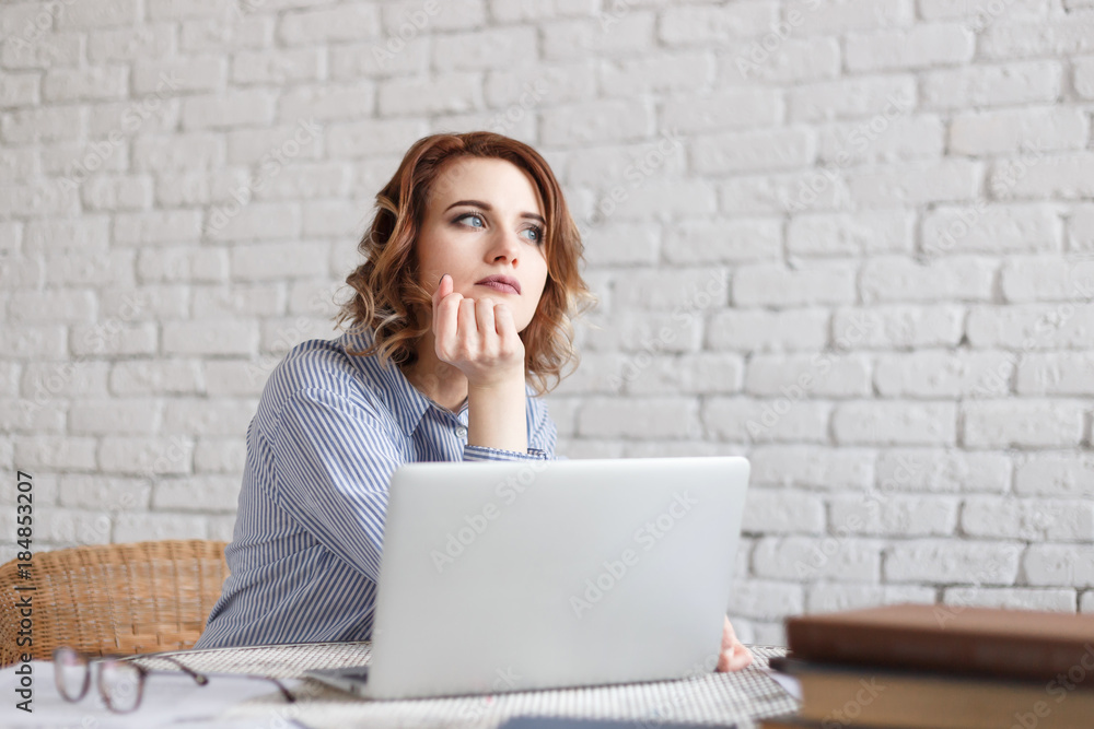Young woman dreams while working Young woman dreams while working