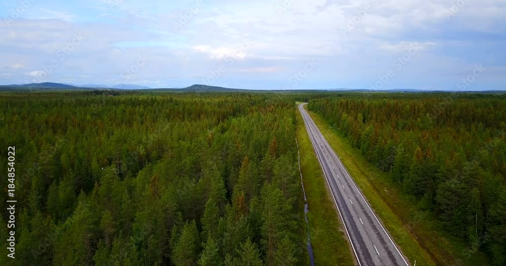 Aerial view of a road without cars immersed in nature with the woods on the eyebrow. Concept of: success, drone, road to travel and journey. Aerial view of a road without cars immersed in nature with the woods on the eyebrow. Concept of: success, drone, road to travel and journey.