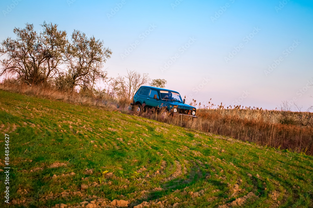 dark green SUV in the grass dark green SUV in the grass