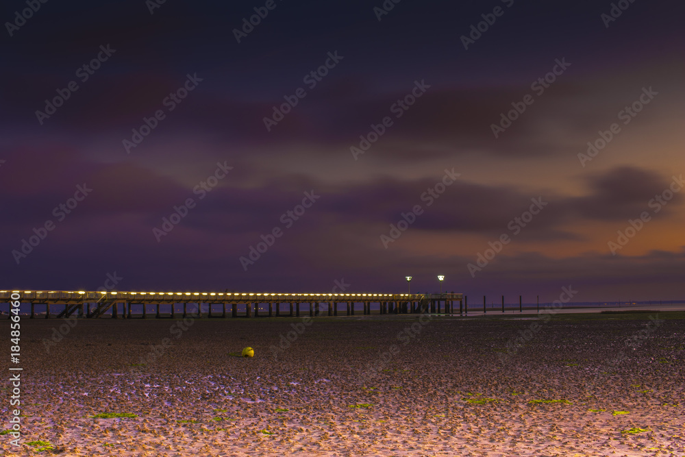 Fototapeta premium The Andernos France pier by night and low tide.