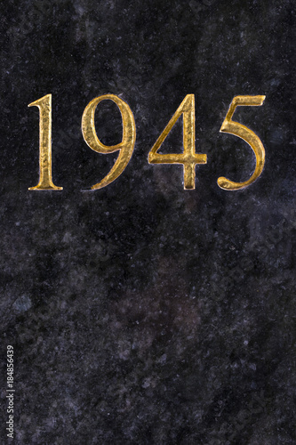 The number 1945, engraved in gold letters on marble.