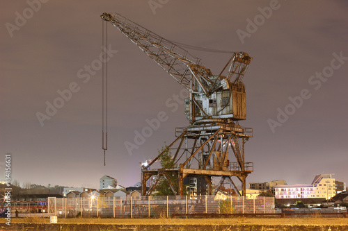 Old abandoned crane on a harbor.