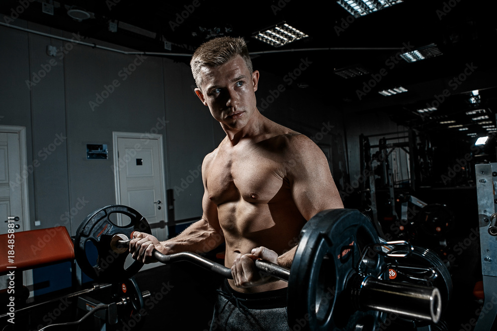 Strong man working in gym	