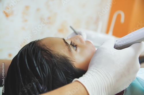 Close up of a little boy during a dentists intervention. Dentist Concept in a blurred background photo