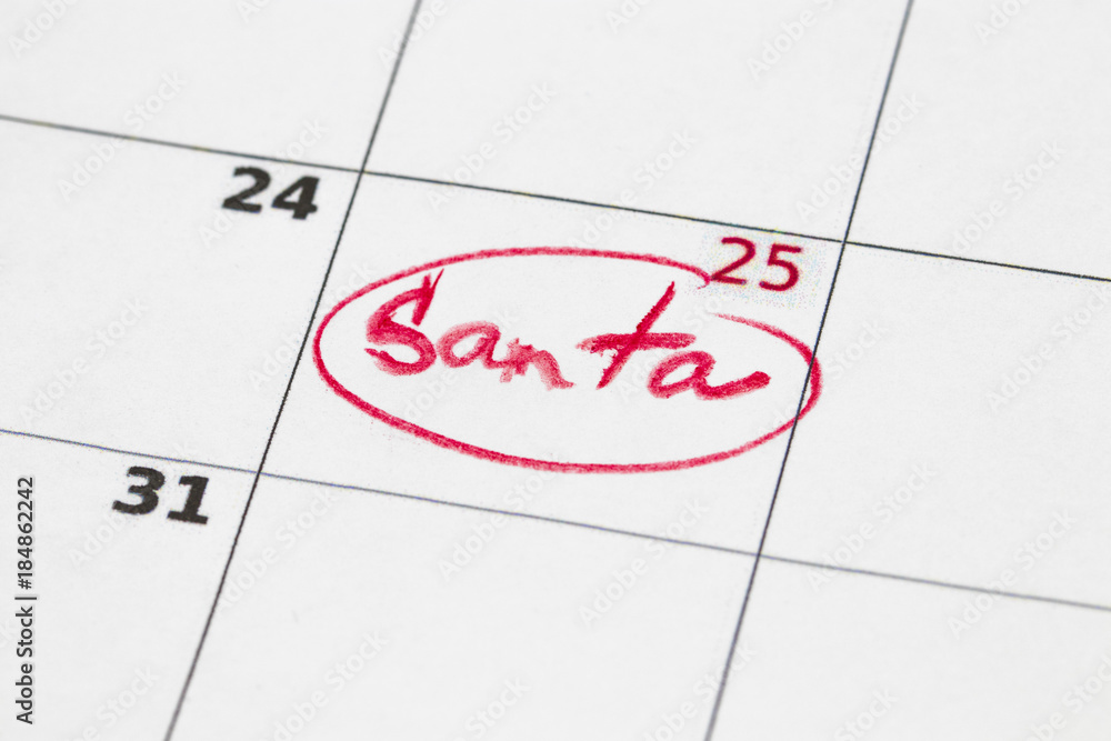 Sheet of wall calendar with red mark on 25 december - Christmas, written Santa Sheet of wall calendar with red mark on 25 december - Christmas, written Santa