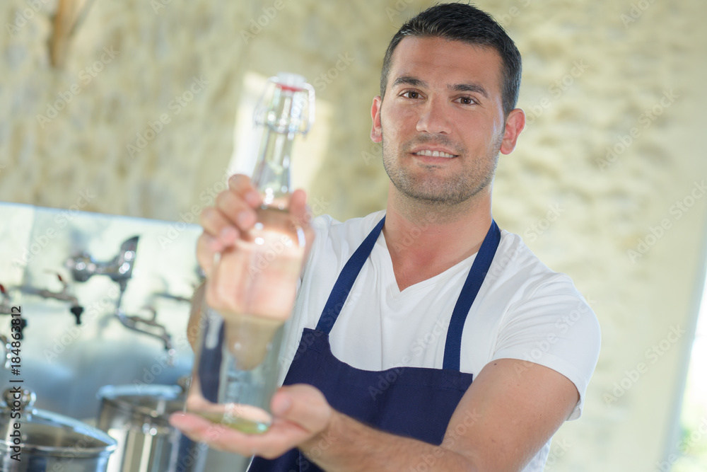 bottling employee showing bottle of lemonade bottling employee showing bottle of lemonade