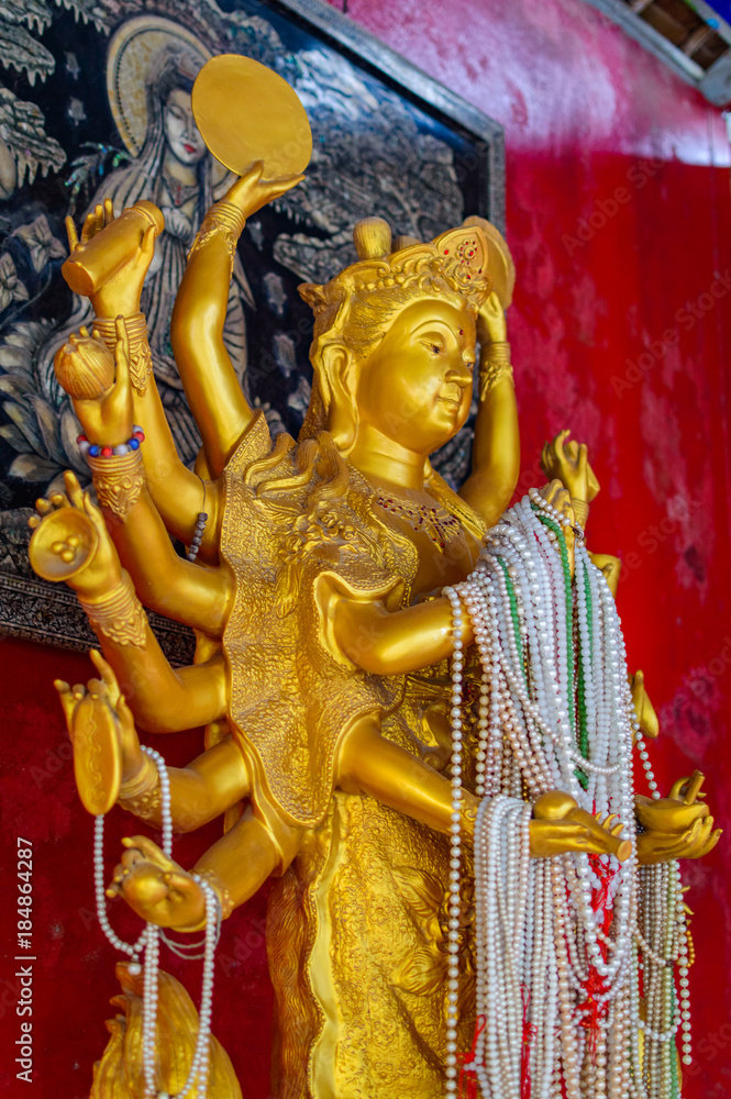 Fototapeta premium Statue of the multi-armed goddess in thailand temple