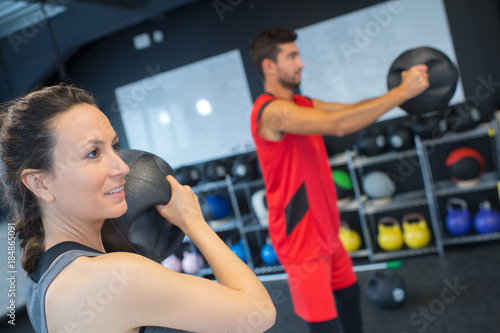 man and woman working out in gym using accessory
