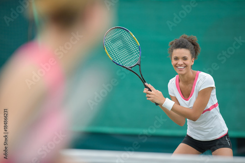 happy young woman playing tennis © auremar