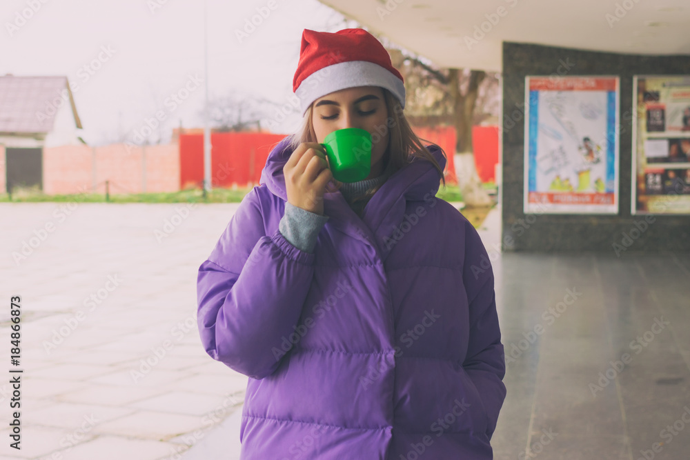 Pretty young girl drinks coffee or tea, street Pretty young girl drinks coffee or tea, street