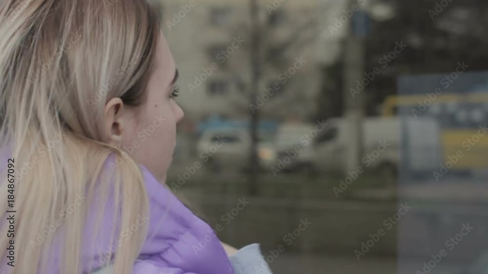 Pretty young girl, reflection in a showcase, street Pretty young girl, reflection in a showcase, street