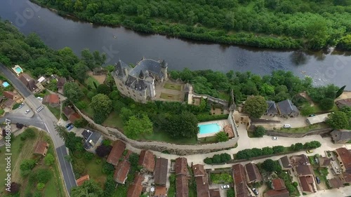 beautiful fantasy style castle with pool next to flowing river, aerial shot photo
