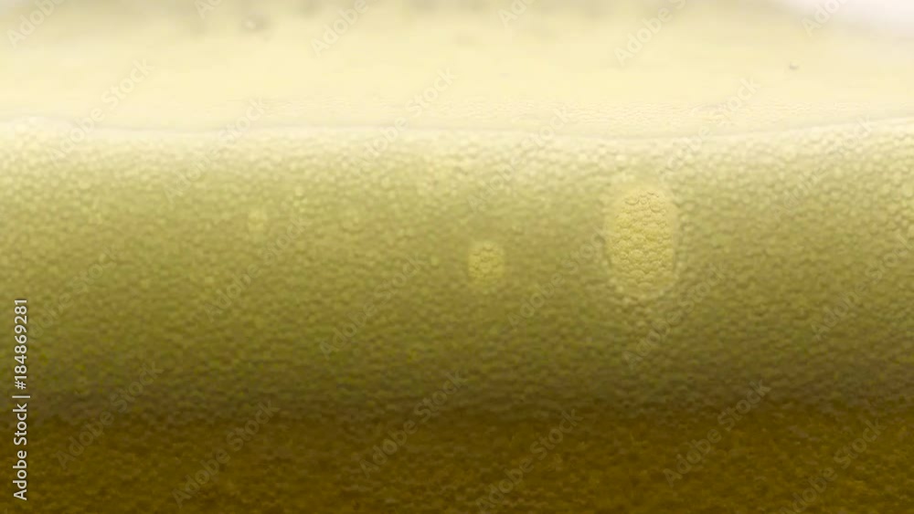 custom made wallpaper toronto digitalSlow motion, pouring and filling cold yellow beer on a clear glass, macro closeup, showing bubbles, foam and movement