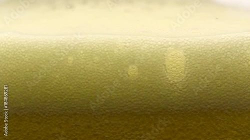 Wallpaper Mural Slow motion, pouring and filling cold yellow beer on a clear glass, macro closeup, showing bubbles, foam and movement Torontodigital.ca