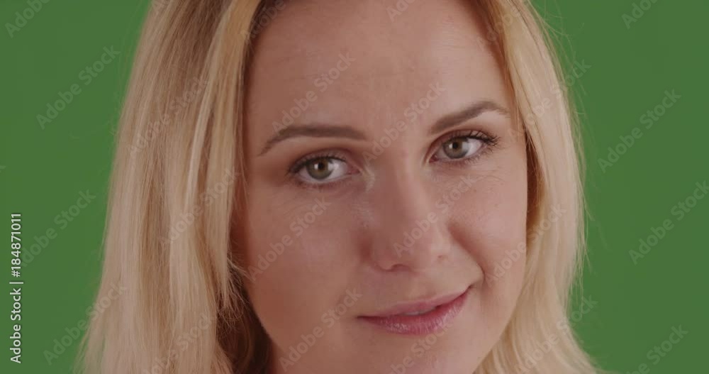 Close-up of woman looking at camera on green screen. On green screen to be keyed or composited. Close-up of woman looking at camera on green screen. On green screen to be keyed or composited.