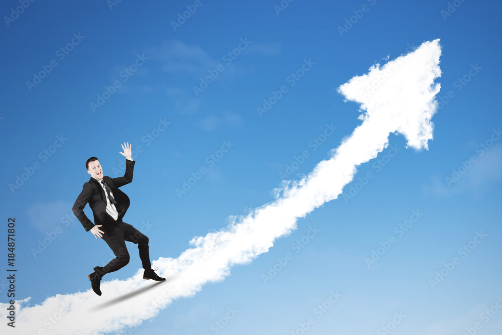 Successful businessman running above clouds