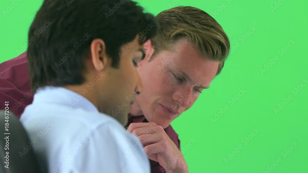 two businessmen having a discussion on greenscreen two businessmen having a discussion on greenscreen