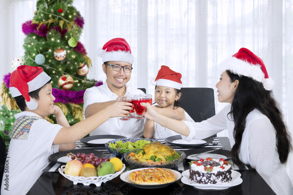 Family toasting drinks together before Christmas dinner Family toasting drinks together before Christmas dinner