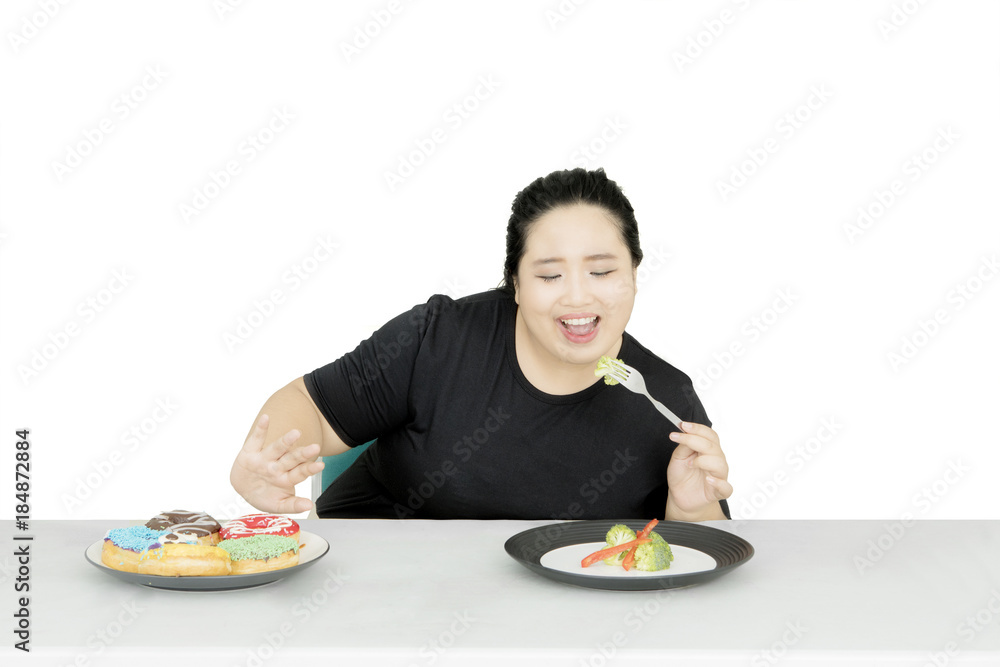 Asian fat woman eating healthy food on studio Asian fat woman eating healthy food on studio