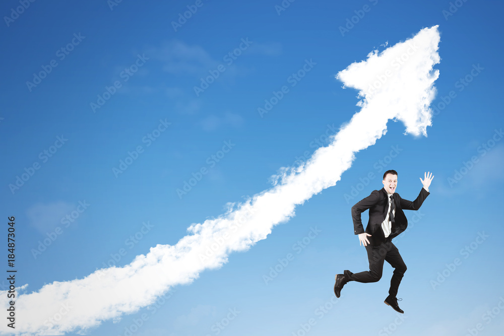 American businessman jumping with upward arrow