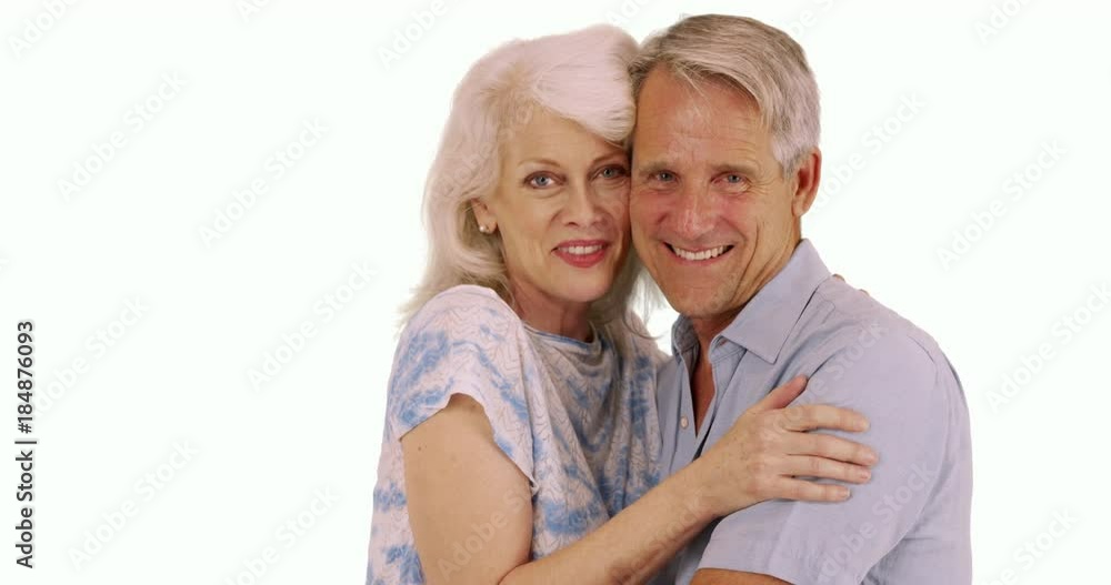 Smiling senior couple looking at camera on white background Smiling senior couple looking at camera on white background