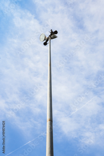 Spot light pole on blue sky and clouds.