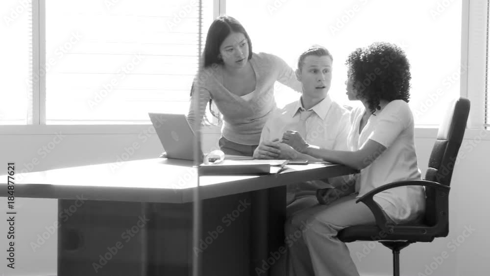 Young business colleagues discussing work at desk area Young business colleagues discussing work at desk area