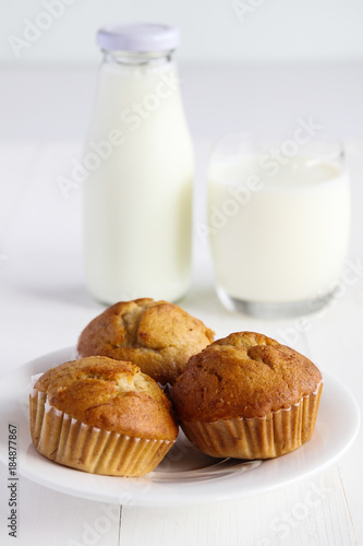Banana cakes with milk on wooden table.