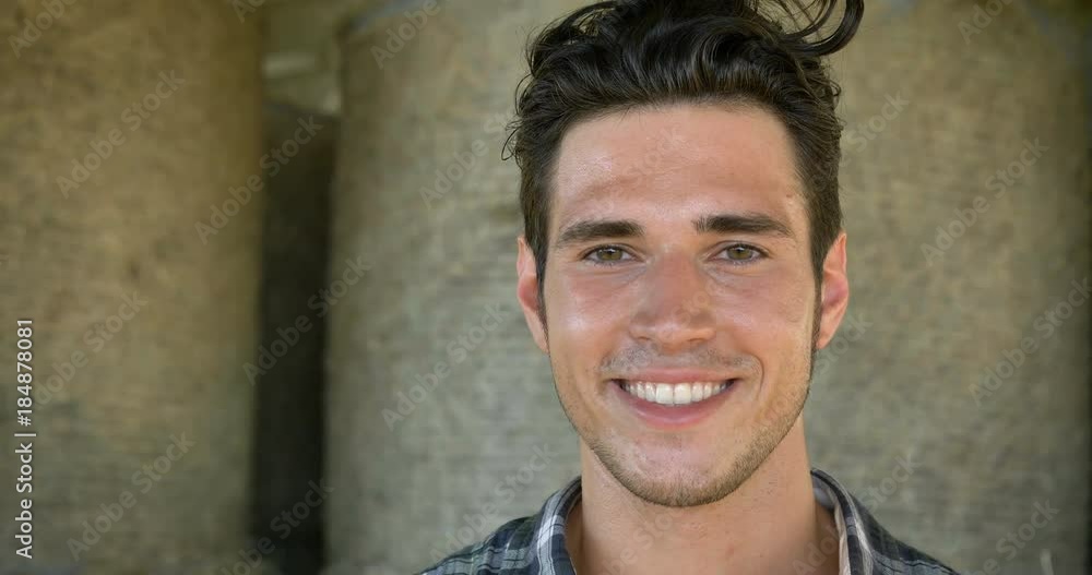 Portrait of a beautiful young farmer (student) working in the field with a tractor, successful smiling, happy, in a shirt, corn field. Concept ecology, transport, farmers, clean air, food, bio product Portrait of a beautiful young farmer (student) working in the field with a tractor, successful smiling, happy, in a shirt, corn field. Concept ecology, transport, farmers, clean air, food, bio product