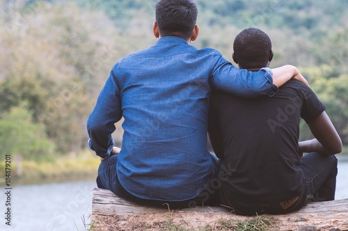 Photos Concept of best friends,African man and asian man  hugging with happy