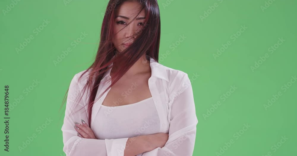 asian woman standing at the beach smiling at camera on green screen. On green screen to be keyed or composited. asian woman standing at the beach smiling at camera on green screen. On green screen to be keyed or composited.