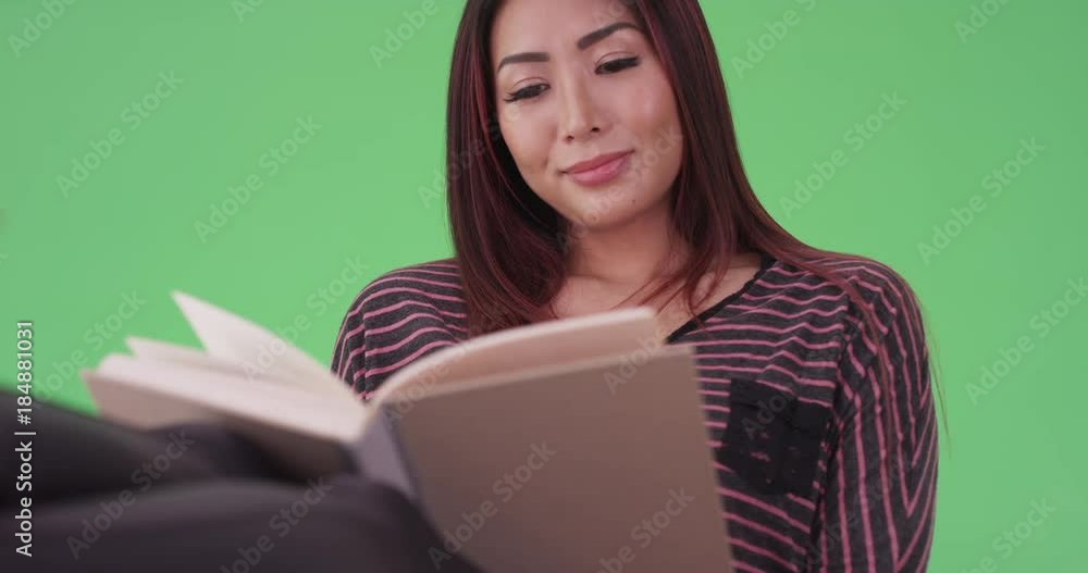 asian woman reading a book on green screen. On green screen to be keyed or composited. asian woman reading a book on green screen. On green screen to be keyed or composited.