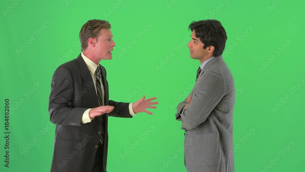 two businessmen standing and talking on greenscreen two businessmen standing and talking on greenscreen