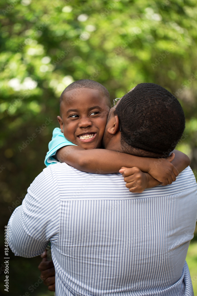 Father hugging his his son.